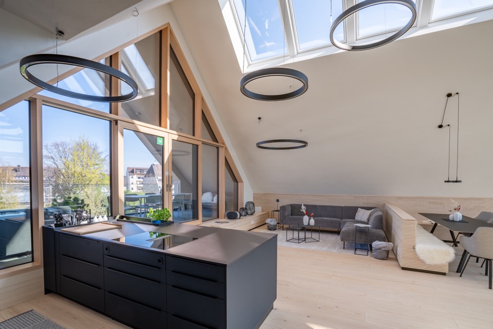 Dachgeschoss mit Kochinsel und Loungebereich
